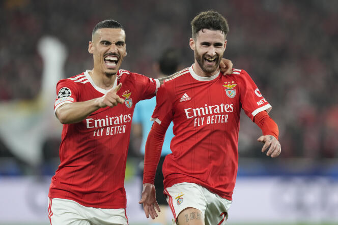 Benfica's Rafa Silva, right, celebrates after scoring his side's opening goal during the Champions League, round of 16, second leg soccer match between Benfica and Club Brugge at the Luz stadium in Lisbon, Portugal, Tuesday, March 7, 2023.
