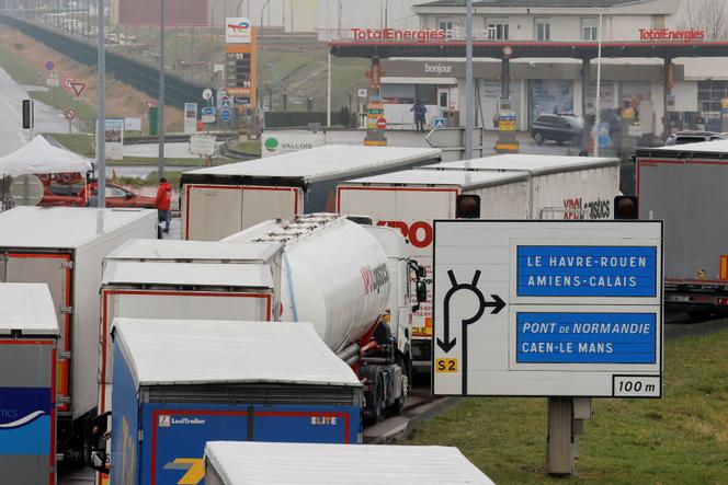 Trucks are seen in a queue as French energy workers on strike gather at a roadblock close to the TotalEnergies refinery in Gonfreville-L'Orcher, near Le Havre, France, March 8, 2023. 