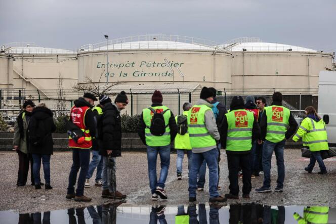 Protesters stand in front of the oil warehouse in Gironde, March 8, 2023.
