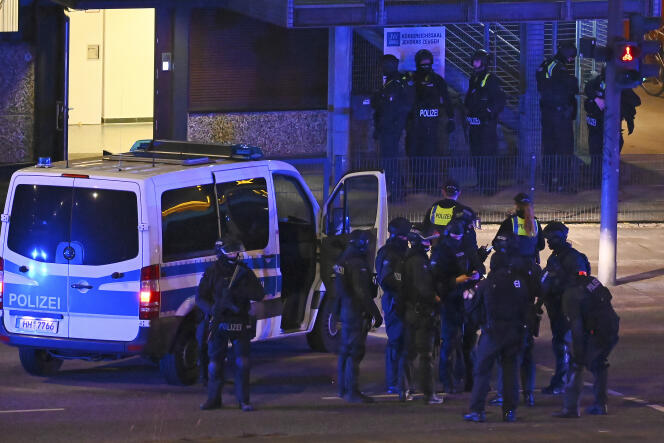 Armed police officers near the scene of a shooting in Hamburg, Germany on Thursday March 9, 2023 after one or more people opened fire in a church.