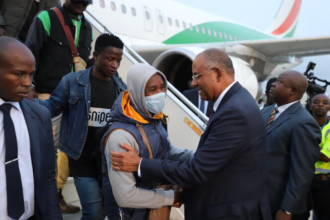 Repatriates returning from Tunisia are greeted on the tarmac at Abidjan's Felix-Houphouet-Boigny Airport by Ivorian Prime Minister Patrick Achi on March 4, 2023.