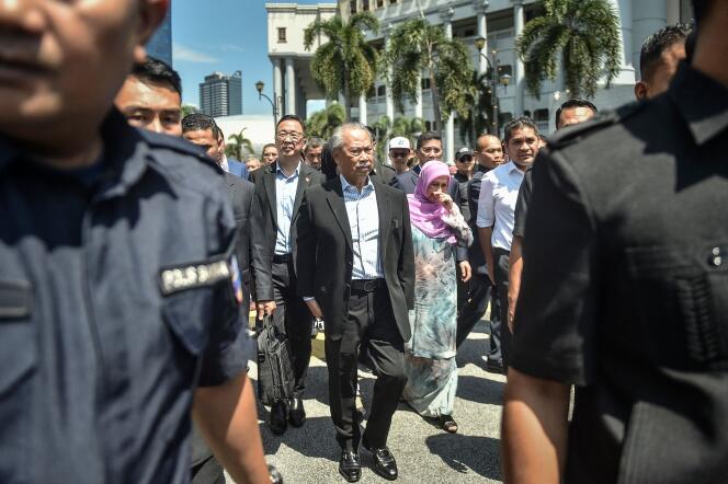 Former prime minister of Malaysia and Perikatan Nasional (PN) chairman Muhyiddin Yassin (C) walks outside Kuala Lumpur High Court after being charged with corruption in Kuala Lumpur on March 10, 2023. 
