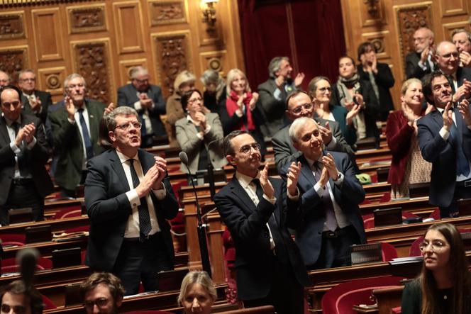 Right-wing senators, including Bruno Retailleu, president of the Les Républicains group, applaud as the Senate goes to vote on the pension reform bill, in Paris, on March 11, 2023.