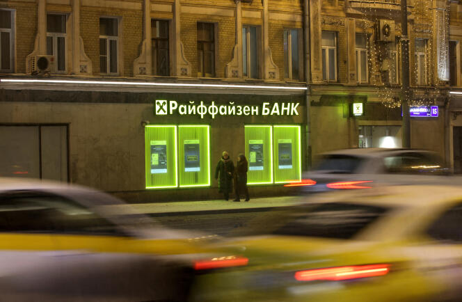 Cars drive past a Raiffeisen Bank branch in Moscow, Russia, February 11, 2023.