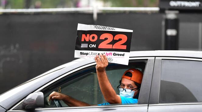 In this file photo taken on October 22, 2020, app-based drivers from Uber and Lyft demonstrate in a trailer outside Los Angeles City Hall where elected leaders are holding a conference urging voters to reject during of the Nov. 3 election, Proposition 22, which would classify app-based drivers as independent contractors, not employees or agents.