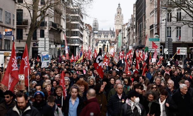 Protesters march during a demonstration on a 8th day of strikes and protests across the country against the government's proposed pensions overhaul in Lille, northern France, on March 15, 2023.