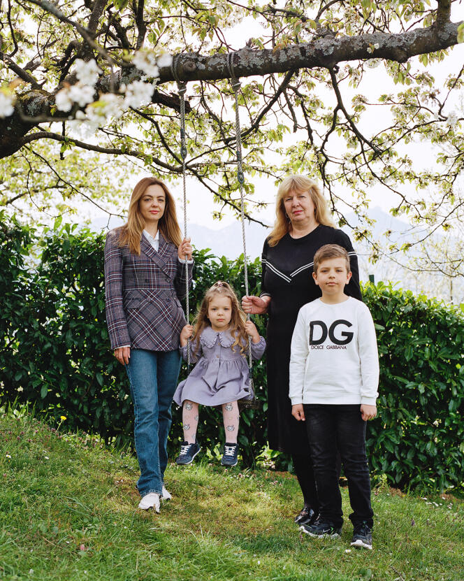Halina Duchenko, grandmother (right), Ivan's wife, Marina, and her two children, Vira and Andrii, in the garden of the Hivert family in Chambery in April 2022.
