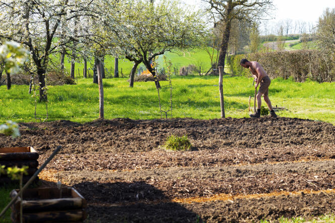 Europe, France, Burgundy, Franche-Comté, Cote d'Or, Epoisses, man preparing soil in a sustainable botanical garden