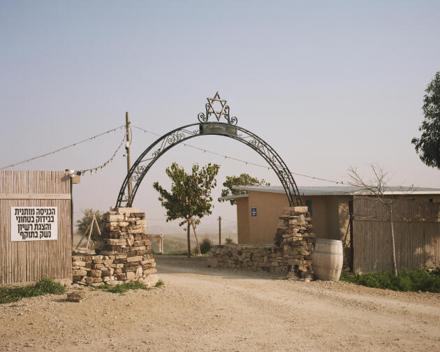 At the entrance to the Keidar settlement, a sign warns that 'entry is subject to security screening and presentation of a valid firearms permit,' February 27, 2023.