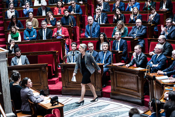 French Prime Minister Elisabeth Borne rises to the podium of the National Assembly on March 16, 2023.