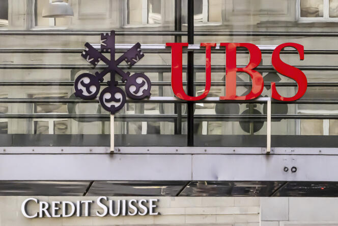 Logos of the Swiss banks Credit Suisse and UBS are seen on two buildings in Zurich, Switzerland, Saturday, March 18, 2023. 