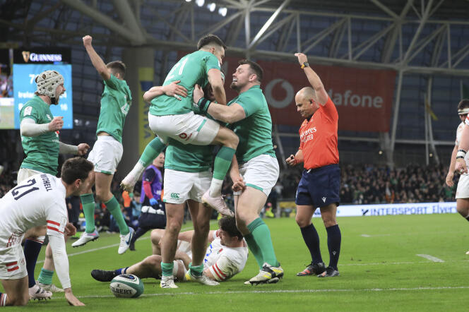 Ireland players celebrate after Rob Herring scored a try during the Six Nations rugby match between Ireland and England at the Aviva Stadium, in Dublin, Saturday, March 18, 2023.