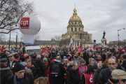 People stage a protest against the retirement bill near Les Invalides, in Paris, Monday, March 20, 2023.