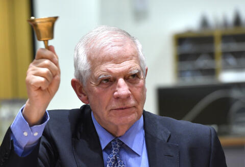 European Union foreign policy chief Josep Borrell rings a bell to signify the start of a meeting of EU foreign and defense ministers at the European Council building in Brussels on Monday, March 20, 2023. European Union foreign ministers on Monday will discuss the situation in Ukraine and Tunisia. (AP Photo/Geert Vanden Wijngaert)