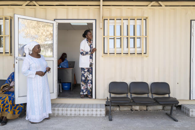 Two healthcare workers talk to a patient from a treatment room at the Integrated Addictions Management Center of Dakar on March 20, 2023.