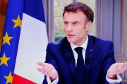 French President Emmanuel Macron is seen on screen as he speaks during a TV interview from the Elysee Palace, in Paris, on March 22, 2023. 