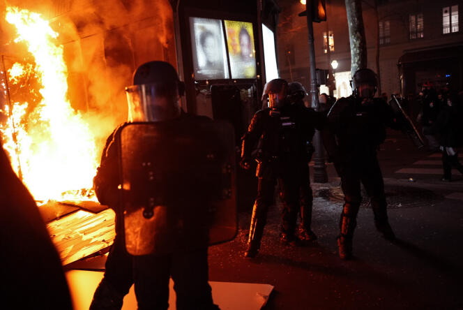 A kiosk on fire after the passage of the procession of demonstrators, in Paris, on March 23, 2023.