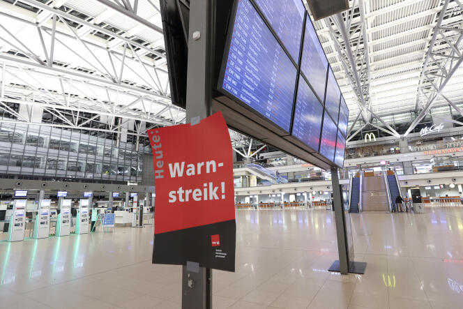 A poster “Attention, strike!  at Hamburg Airport (Germany), March 26, 2023.  
