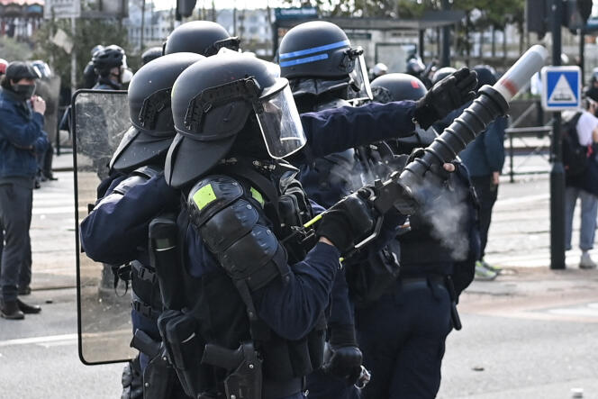 French police officer fires a tear gas canister during clashes on the sidelines of a demonstration in Nantes, western France, on March 28, 2023.