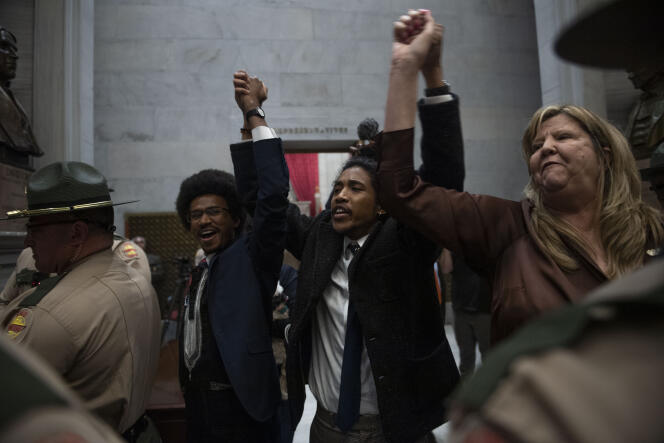 Rep. Justin Pearson, Rep. Justin Jones, Rep. Gloria Johnson People hold their hands up as they exit the House Chamber doors at Tennessee State Capitol Building in Nashville, Tennessee, Monday, April 3, 2023.