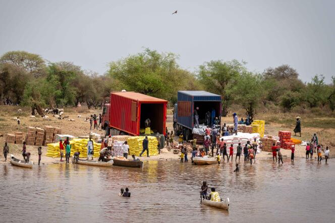 Trucks unload goods transported from Juba on the east bank of the river in Pibor, South Sudan on March 8, 2023.