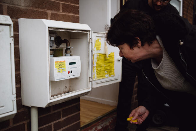 Helen Walker checks her prepaid gas meter in Radcliffe, England on May 6, 2022.