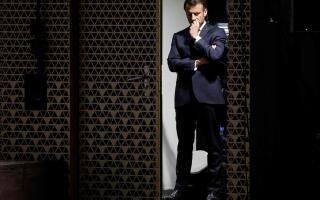 TOPSHOT - French President Emmanuel Macron awaits his introduction backstage before delivering a speech to the Nexus Institute in the Amare theatre in The Hague on April 11, 2023 as part of a state visit to the Netherlands. (Photo by Ludovic MARIN / AFP)