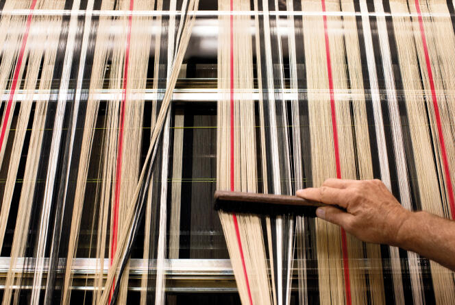 The brand's signature tartan pattern is woven in Yorkshire, England. 