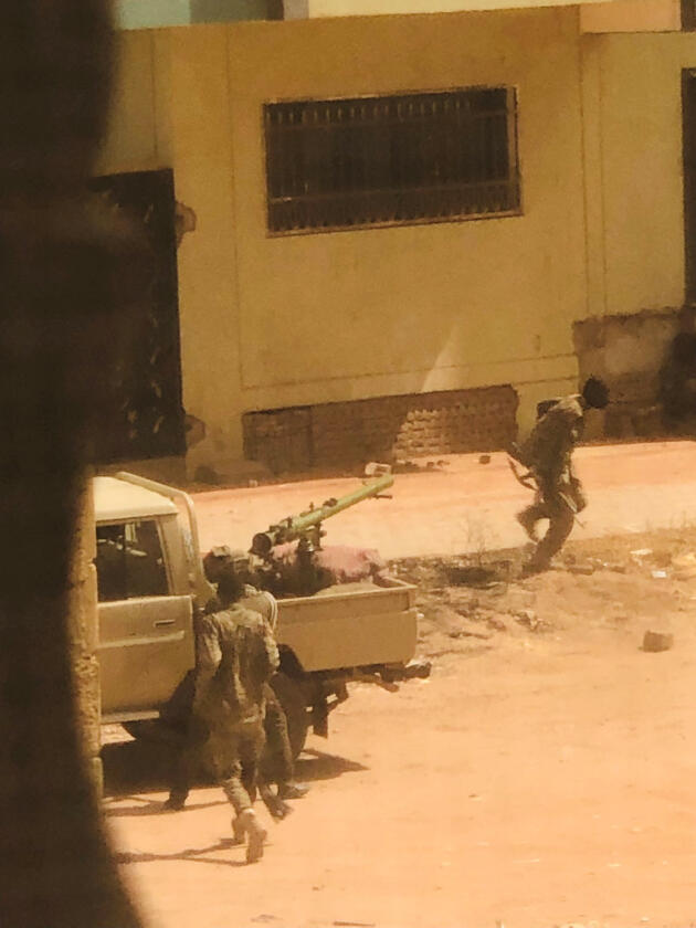 A military vehicle and Sudanese Armed Forces soldiers are seen on a street in Khartoum, Sudan, April 15, in this screenshot obtained from a video on social media.