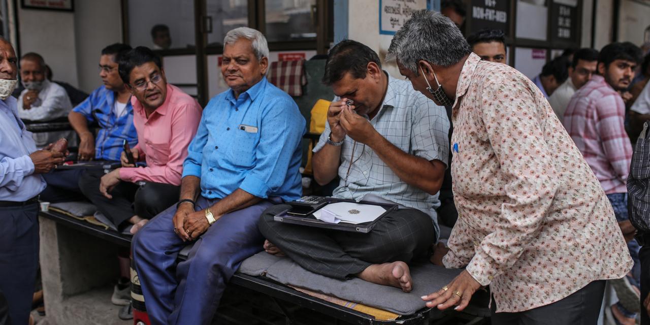 A trader inspects diamonds at a diamond market in Surat, Gujarat, India, on Tuesday, April 12, 2022. Russias invasion of Ukraine is fracturing a billion-dollar trade that spans the permafrost-laden diamond mines of Siberia, secretive trade houses in Antwerp, dusty polishing powerhouses in India and New Yorks glittering designer jewelry stores. Photographer: Dhiraj Singh/Bloomberg via Getty Images