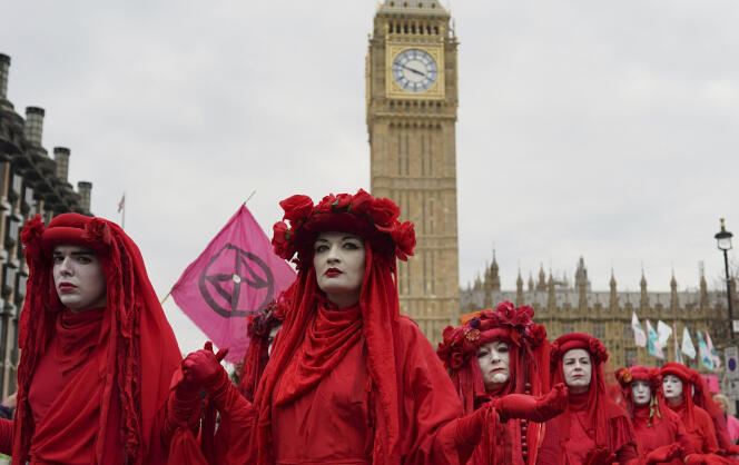 Members of the climate activist 'Red rebel brigade' take part in the Extinction Rebellion protest in London on April 22, 2023.
