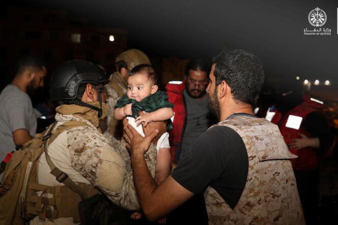 Saudi Royal Navy officers assist a child onboard their navy ship as they evacuate Saudi and other nationals are through Saudi Navy Ship from Sudan to escape the conflicts, Port Sudan, Sudan, April 22, 2023. 