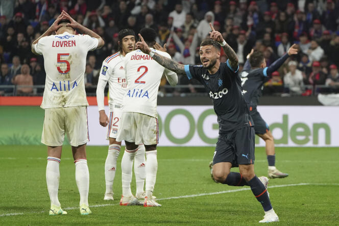 Marseille's Jonathan Clauss celebrate after Lyon's Malo Gusto scored an own goal during the French League One soccer match between Lyon and Marseille at the Groupama stadium, in Decines, near Lyon, France, Sunday, April 23, 2023.