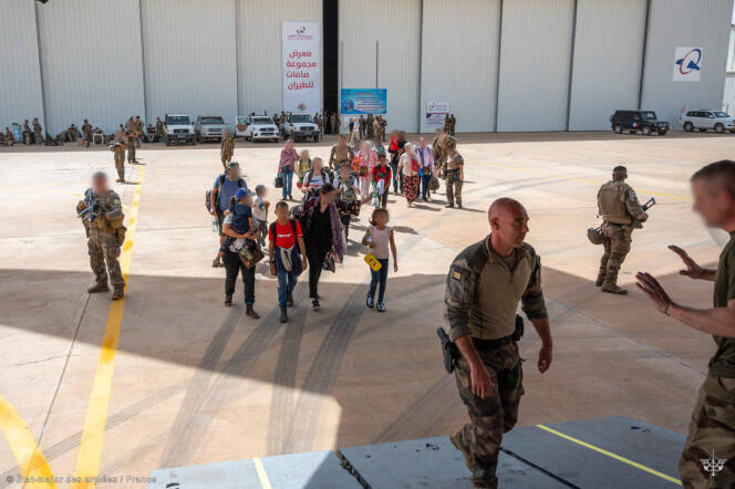 This photo posted by the military general staff shows French and other nationals boarding a plane to Djibouti at the French military airbase in Khartoum, as part of 'Operation Sagittarius,' the evacuation operation.  April 23, 2023.