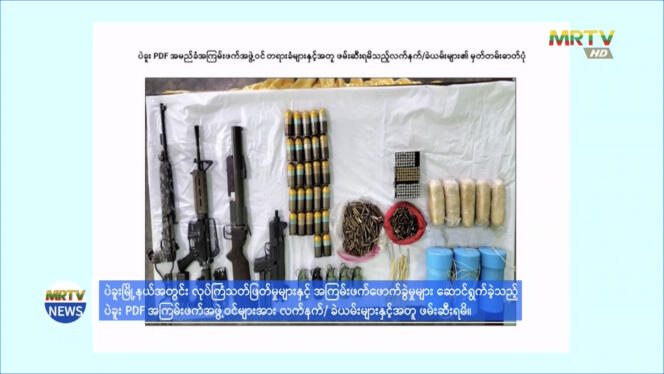 A screenshot from a news report on Burma's state-run MRTV News showing a seizure of weapons that the military says it found in the home of a suspect described as a 