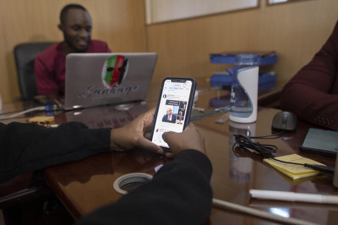 Surfing social media on a mobile phone, in Thika, central Kenya, in April 2022.