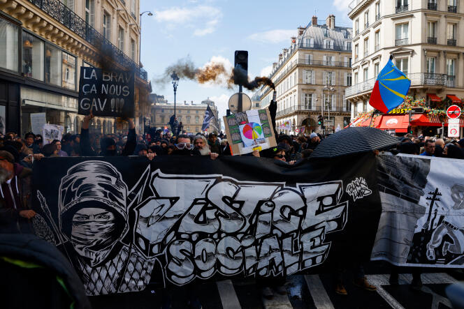 Des manifestants tiennent une banderole signée Black Lines lors d’une manifestation contre la réforme des retraites à Paris, le 13 avril 2023. 