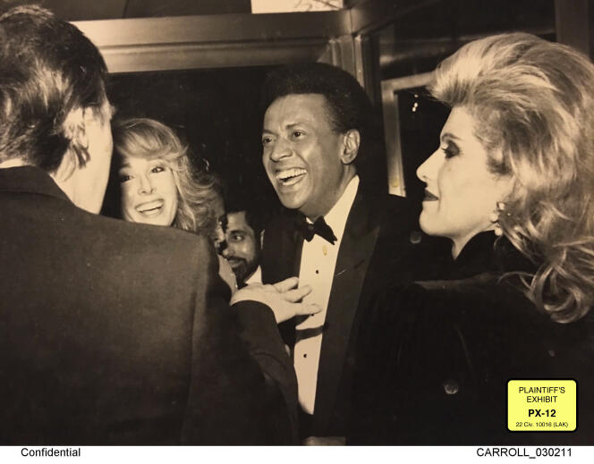 Security provided photo of Donald Trump standing in front of E.  Jean Carroll, at a party, they allegedly met in 1996.