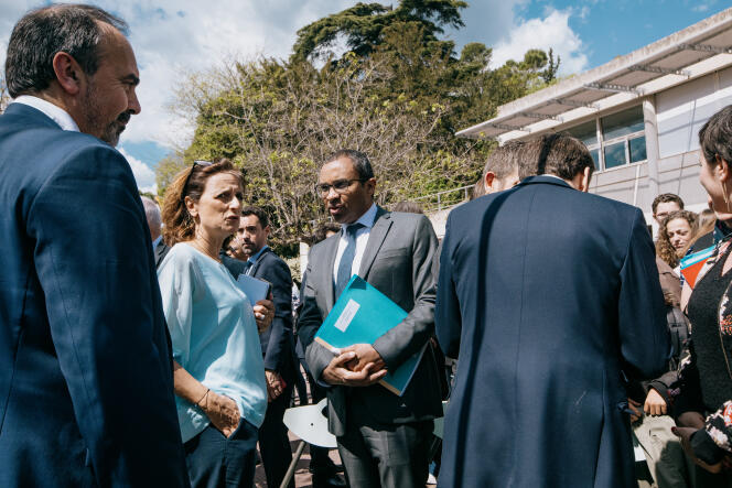 The Minister of National Education, Pap Ndiaye, and Emmanuel Macron (from the back), in the courtyard of the Louise-Michel college, in Ganges (Hérault), April 20, 2023.