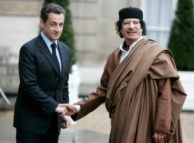 French President Nicolas Sarkozy, left, greets Libyan leader Moammar Gaddafi upon his arrival at the Elysee Palace, in Paris on December 10, 2007.
