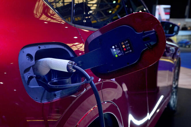 A power cable plugged into the new Mazda CX-60 electric car on display at the e-Motor show in Beirut on May 10, 2023. 