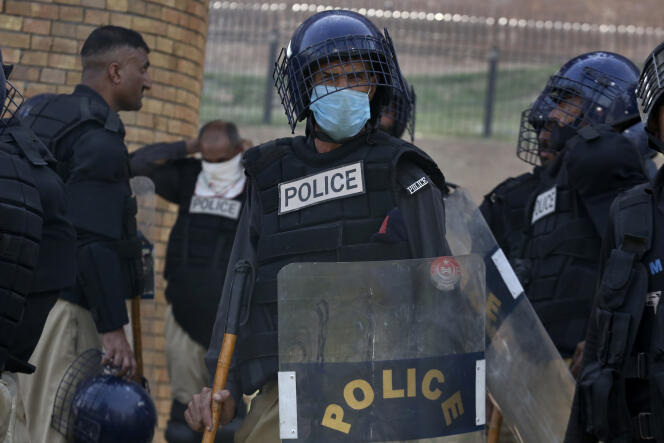 Police officers with riot gear stand alert to ensure security, in Peshawar, Pakistan, Thursday, May 11, 2023. 