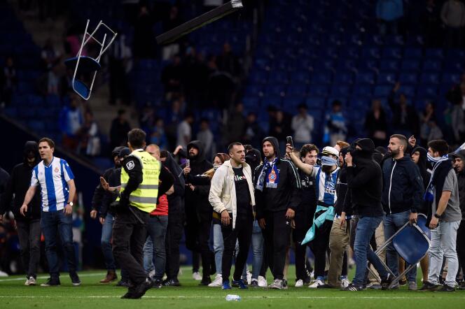 Espanyol fans react to Barcelona's victory invading the pitch after the Spanish league football match between RCD Espanyol and FC Barcelona at the RCDE Stadium in Cornella de Llobregat on May 14, 2023. Barcelona won Spain's La Liga for the first time since 2019 by thrashing Espanyol 4 -2 today, wrestling the title from rivals Real Madrid.  The Catalan giants clinched their 27th Spanish championship with an emphatic derby victory, with Robert Lewandowski scoring twice, alongside Alejandro Balde and Jules Kounde's goals.  (Photo by Josep LAGO / AFP)