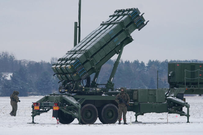 Polish military personnel stand next to a Patriot missile launcher at Babice Airport, Poland, February 7, 2023.