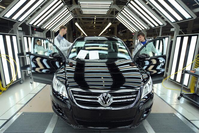 Employees checking a car leaving the assembly line of German car maker Volkswagen's plant in Kaluga, Russia, on October 20, 2009