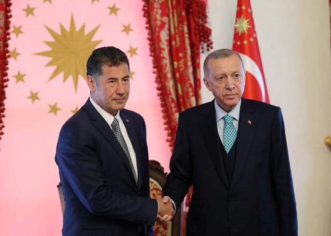 Turkish President Tayyip Erdogan and Sinan Ogan pose before a meeting in Istanbul, Turkey, May 19, 2023.