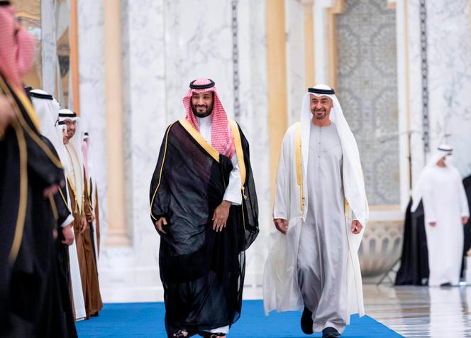 Saudi Prince Mohammed bin Salman, left, and his Emirati counterpart Sheikh Mohammed bin Zayed at a reception in Abu Dhabi on December 7, 2021, in a photo provided by the official Emirati news agency WAM.