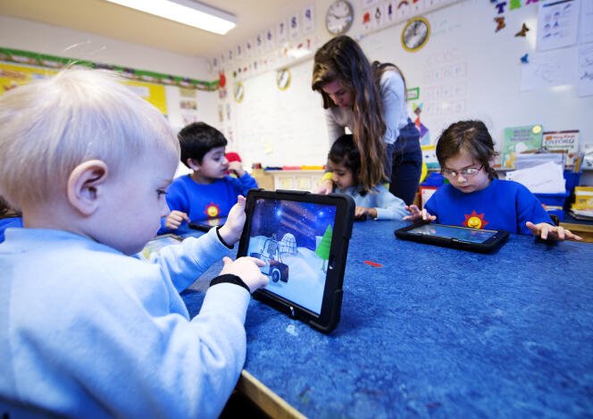 Kindergarten students work with tablets at a school in Stockholm on March 3, 2014.