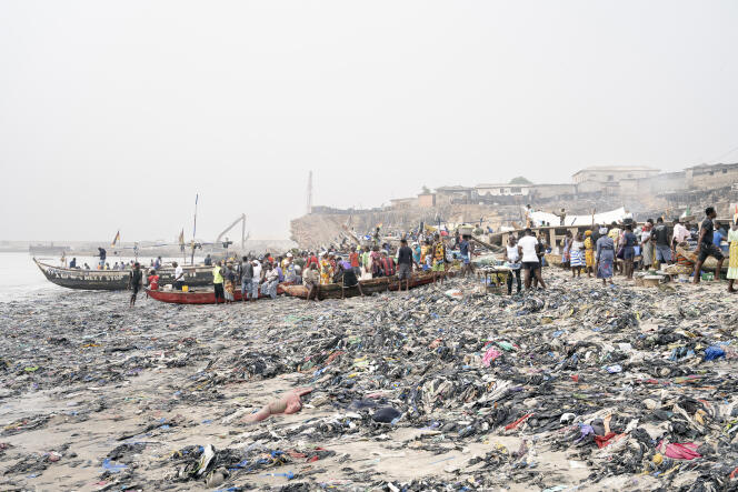 At the fishing port of Accra, the Ghanaian capital, on February 19, 2023. The beach is littered with used clothes from industrialized countries, which arrive in Accra every week.