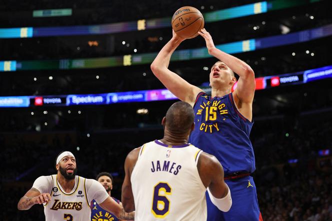 Denver Nuggets player Nikola Jokic attempts a shot as Anthony Davis (left) and LeBron James look on, May 20, 2023, in Los Angeles.